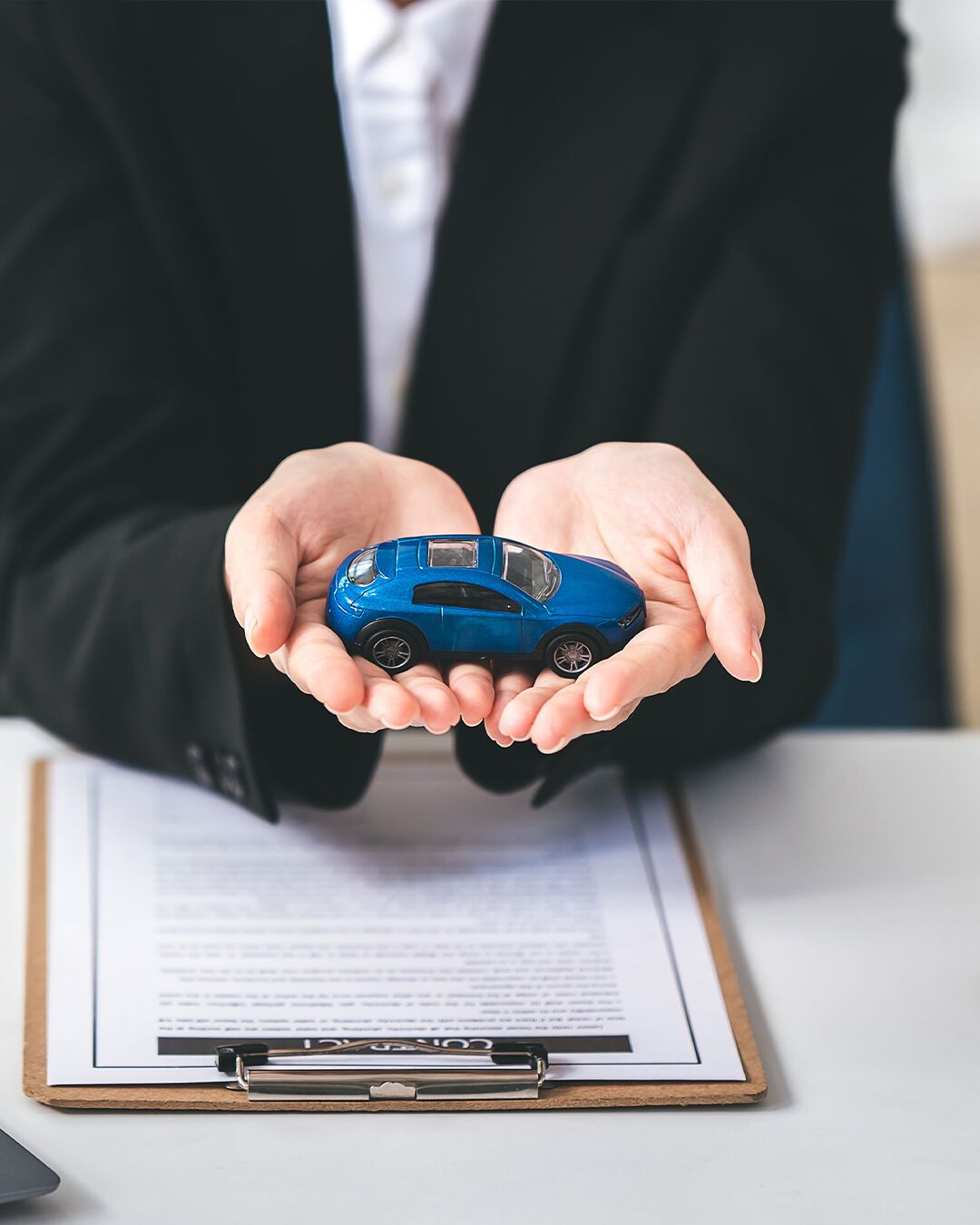 Insurance advisor holding a model car
